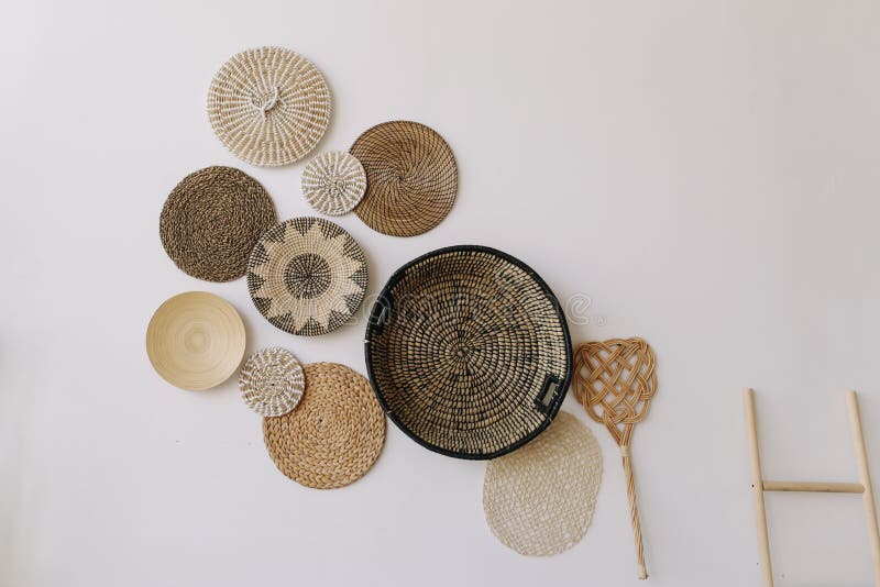 Boho style, minimal home interior design. Decorative straw plates on the wall. Exotic interior. stock photo