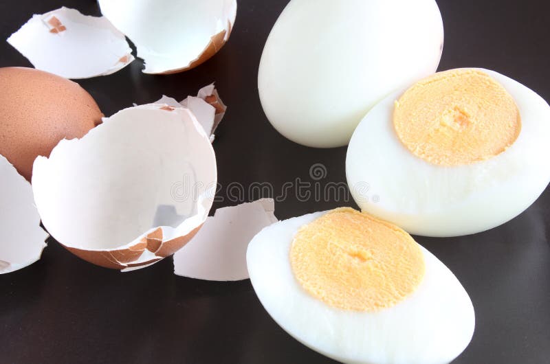 Boiled eggs and half with shells on a black background. Boiled chicken eggs are an excellent source of protein. Suitable for people of all ages stock photo Boiled eggs and half with shells on a black background. Boiled chicken eggs are an excellent source of protein. Suitable for people of all ages stock photo