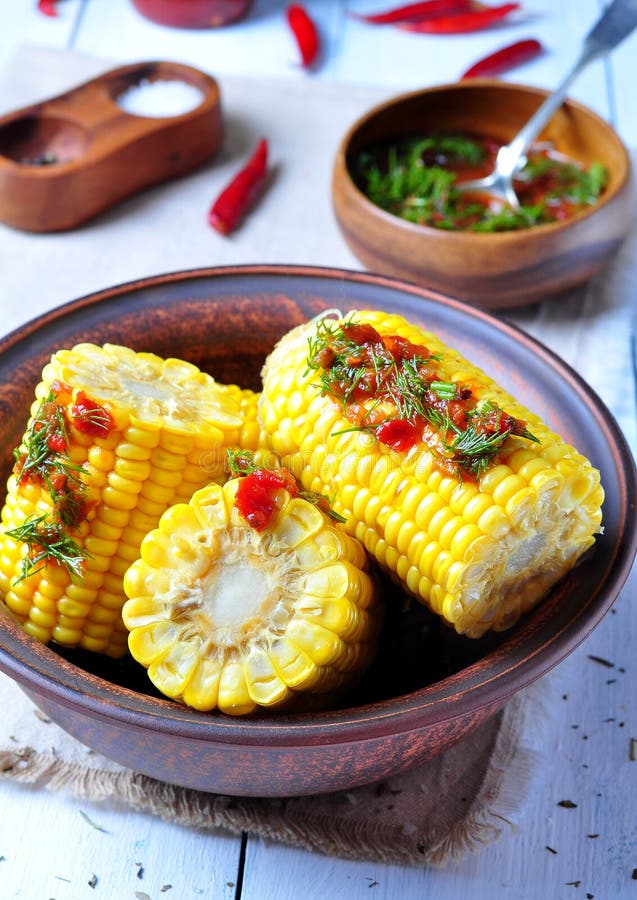Boiled Corn with Hot Tomato Sauce, Herbs, Salt and Spices Stock Photo