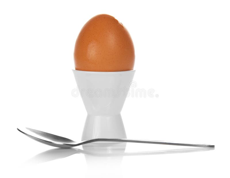 Boiled egg in support and teaspoon