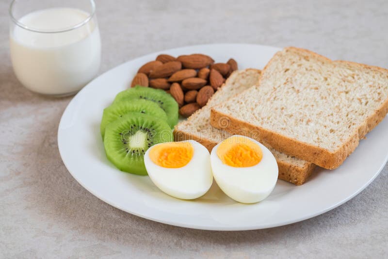 Boiled egg, whole wheat bread, kiwi, almonds and milk glass, Healthy food