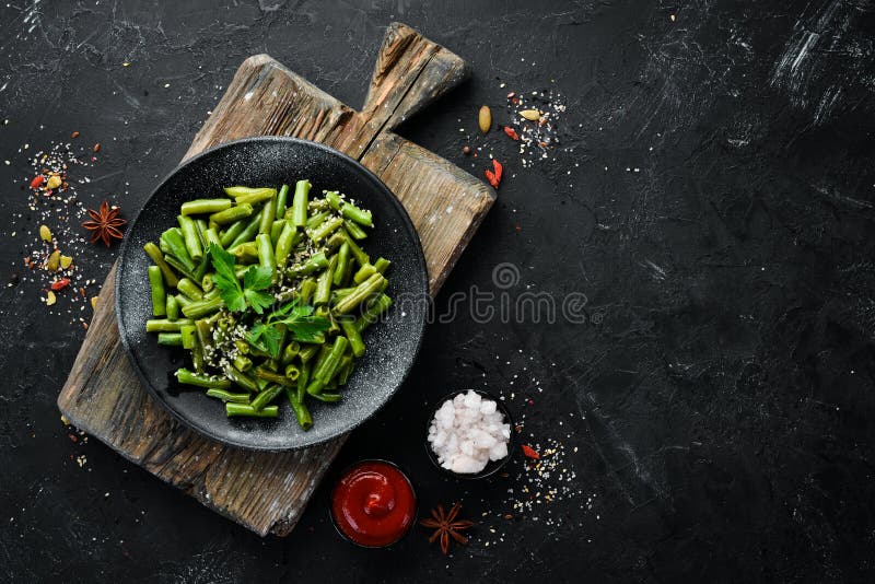 Boiled Green Asparagus Bean. in a Black Plate. Top View Stock Photo