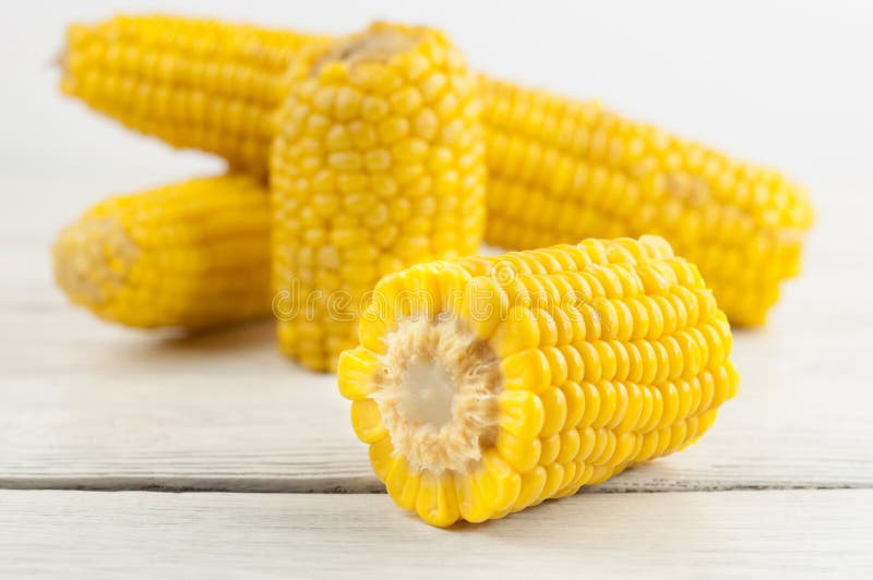 Boiled yellow ripe whole corn and slices of corn