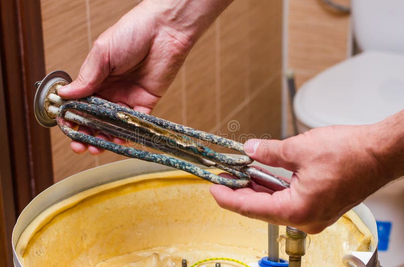 Boiler Repair, Replacement of Broken Water Heating Element Stock Image