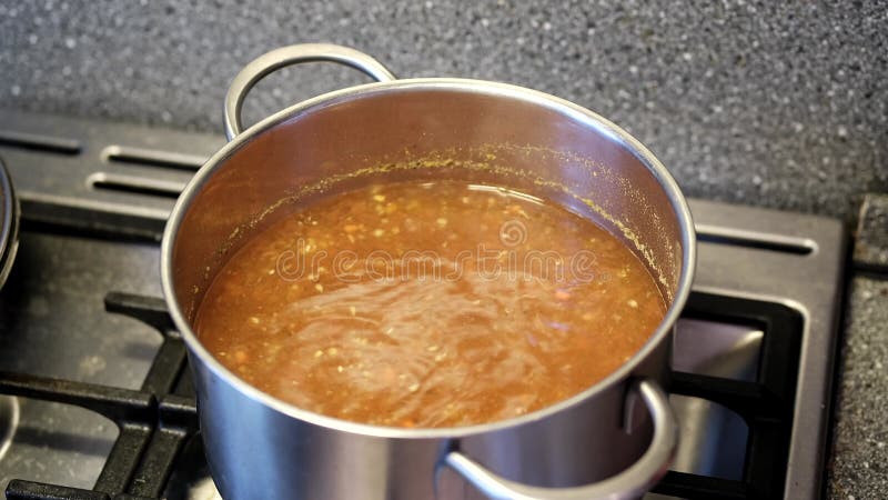 Boiling Broth Bubbling in a Pot Under a Transparent Lid Stock Video