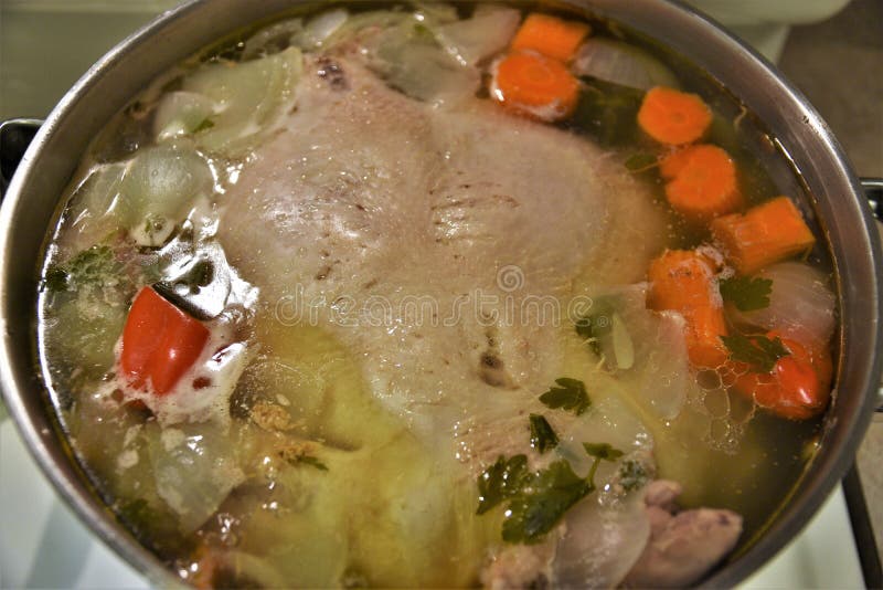 Boiling Chicken in Pot with Vegetables To Make Chicken Broth Stock