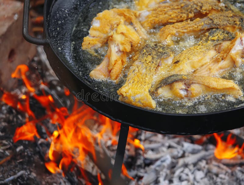 Boiling in Oil on Opened Fire, Frying Fish Fillet. Stock Photo Image