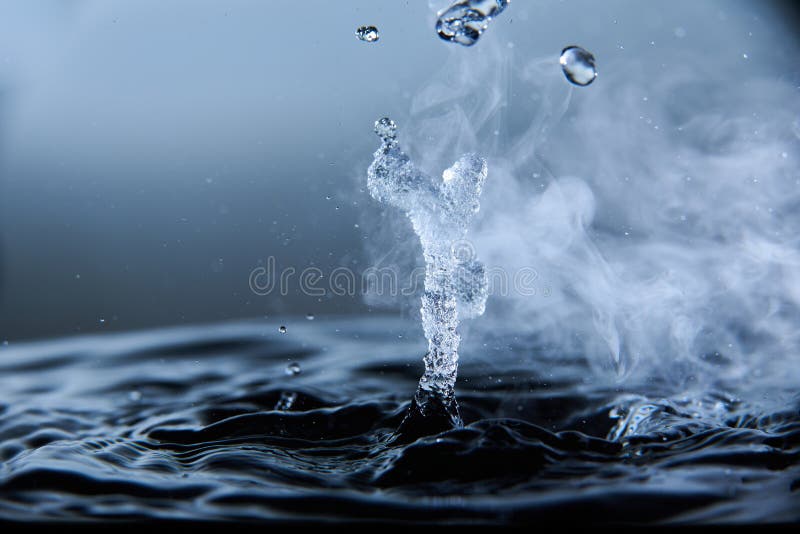 Boiling Water Splash with Steam on Black Background Closeup Stock Photo