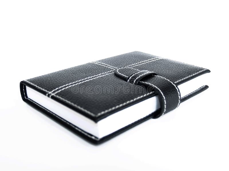 Black leather cased notebook, on white bacground with pen for writing. Black leather cased notebook, on white bacground with pen for writing.