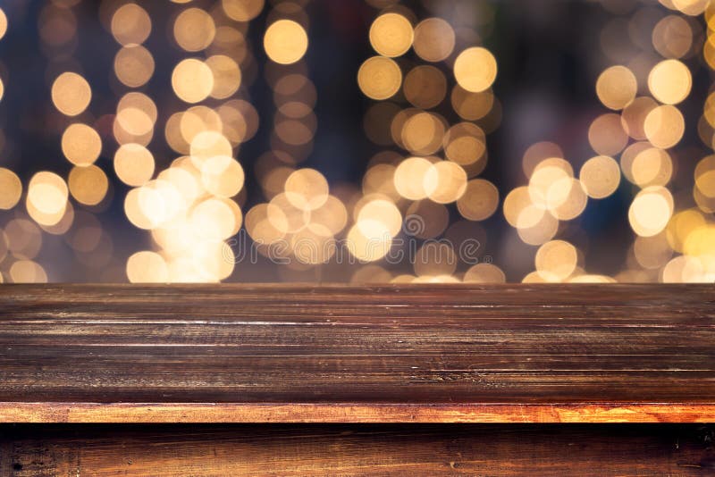 Top of wood table with christmas abstract background light bokeh from Xmas tree at night party in winter - Empty ready for your product display or montage. vintage color tone. Top of wood table with christmas abstract background light bokeh from Xmas tree at night party in winter - Empty ready for your product display or montage. vintage color tone