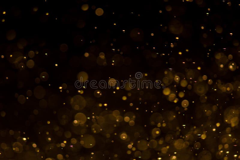 Abstrato bokeh dourado com fundo preto imagens de stock