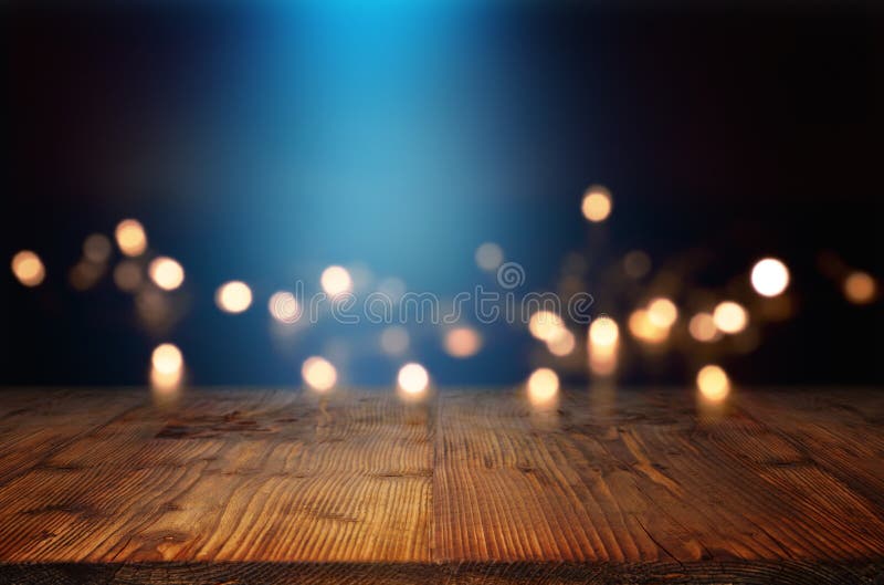 Bokeh background with blue light beam and a wooden table