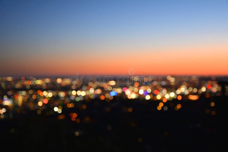 Bokeh lights of a city at sunset.