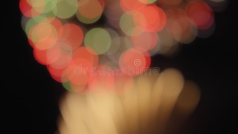 Bokeh lights of real fireworks exploding in the sky during a celebration stock video footage