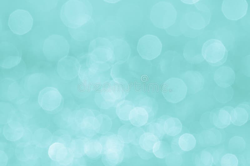 Bokeh soft pastel aqua background with blurred white lights. Festive background.