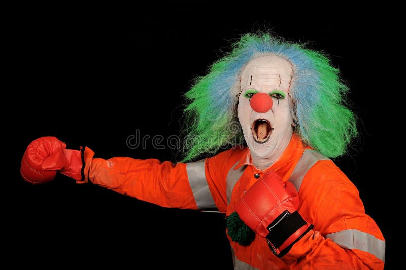 Clown with wig and makeup wearing boxing gloves. Clown with wig and makeup wearing boxing gloves.