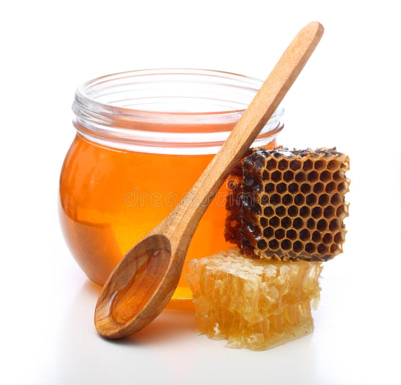 Bol en verre avec du miel et le peigne de tranche images stock Bol en verre avec du miel et le peigne de tranche images stock