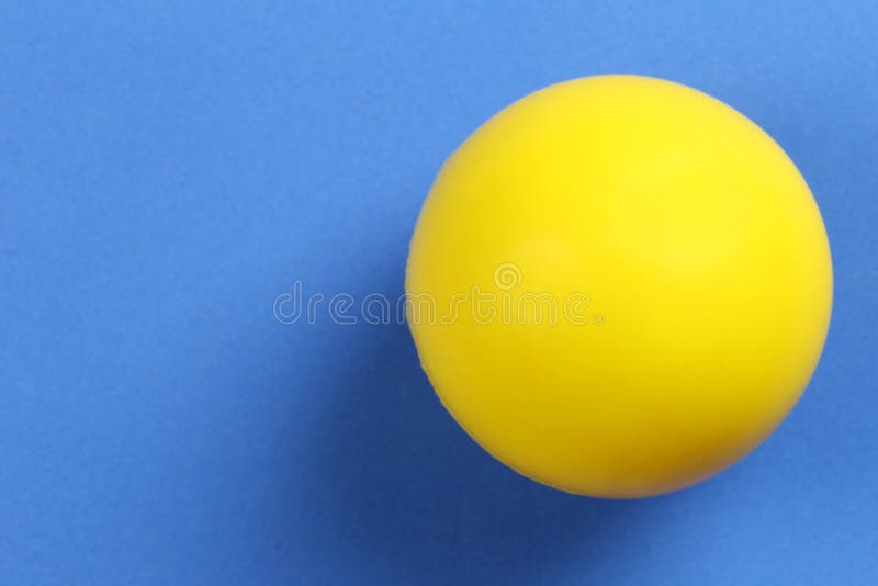 A Bola Amarela é Colocada Sobre Um Fundo Azul Imagem de Stock