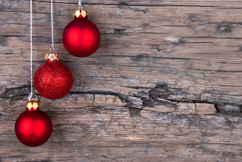 Three Red Christmas Tree Balls on Wood with Copy Space. Three Red Christmas Tree Balls on Wood with Copy Space