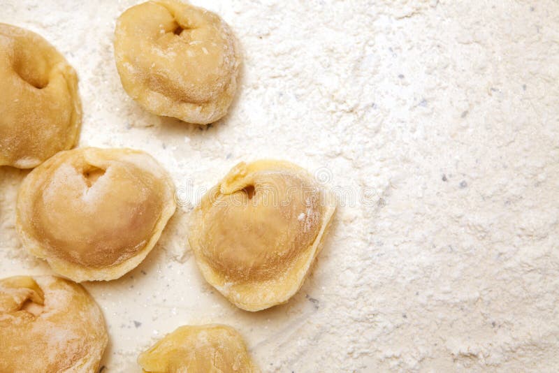 Preparation of dumplings from dough which is in flour, close-up view from above. Preparation of dumplings from dough which is in flour, close-up view from above