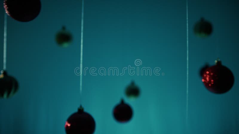 Bolas de Natal penduradas num fio com um fundo azul video estoque