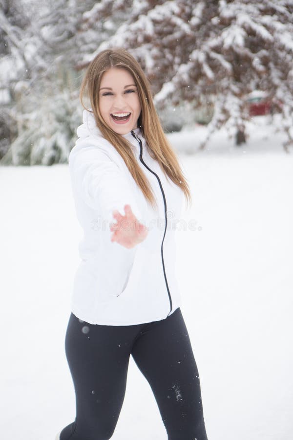 Bolas de nieve de risa y que lanzan de la mujer joven foto de archivo Bolas de nieve de risa y que lanzan de la mujer joven foto de archivo