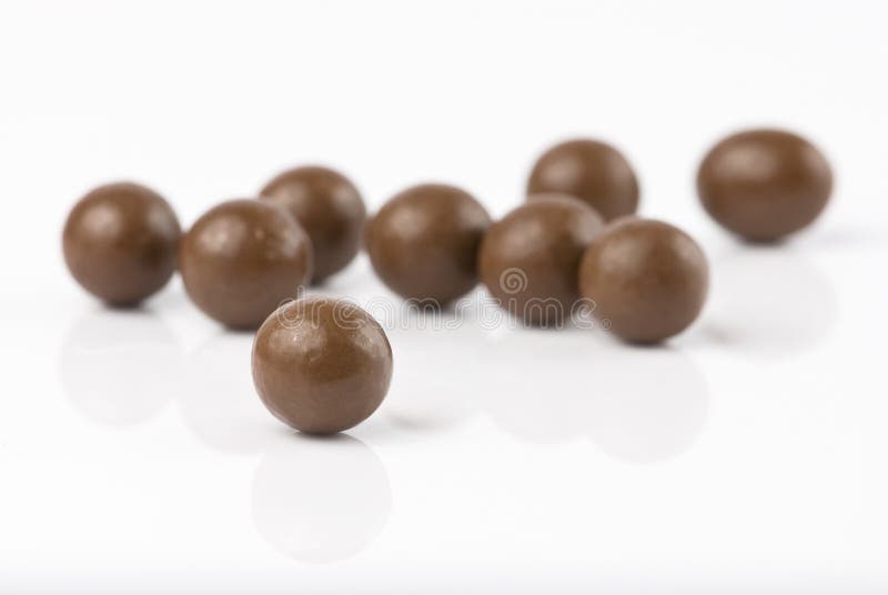 Chocolate balls isolated on white with reflection. Chocolate balls isolated on white with reflection