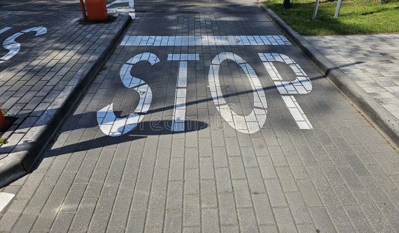 Bold stop sign painted on pavement in urban royalty free stock image