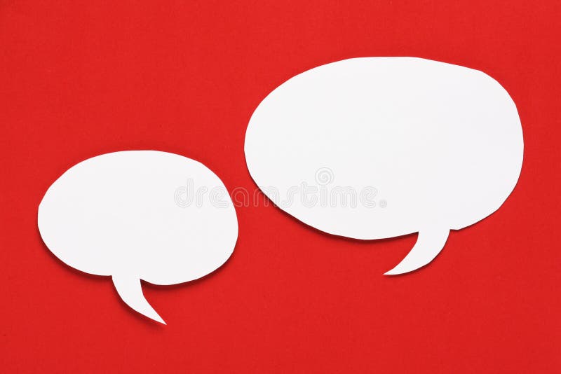 Blank white paper Speech Bubbles with copy space on a red paper background. Blank white paper Speech Bubbles with copy space on a red paper background