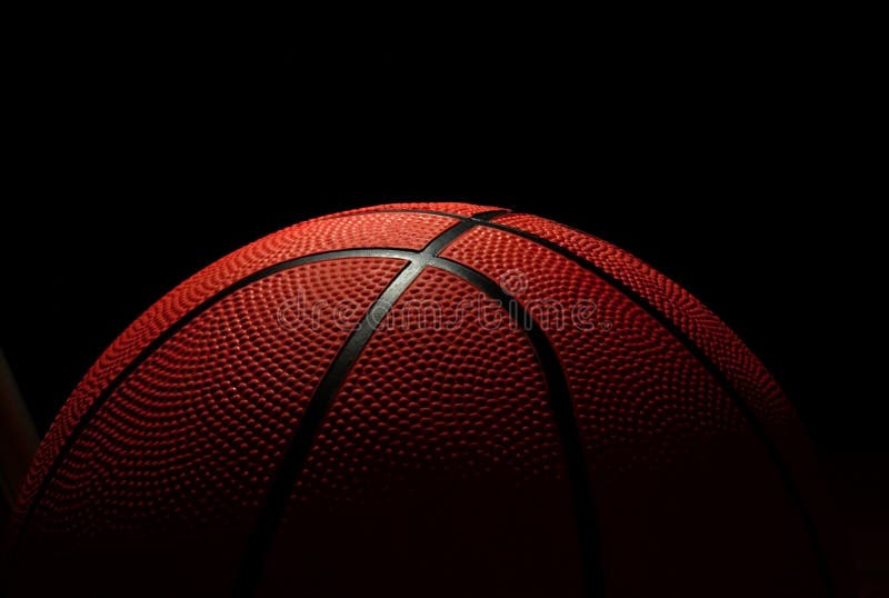 The ball to the basketball on dark background. The ball to the basketball on dark background