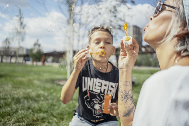 Bolle di salto della famiglia felice all'aperto nel parco e nel divertiresi immagini stock Bolle di salto della famiglia felice all'aperto nel parco e nel divertiresi immagini stock