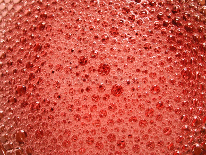 Bolle reali dei Suds del sapone rosse fotografie stock Bolle reali dei Suds del sapone rosse fotografie stock