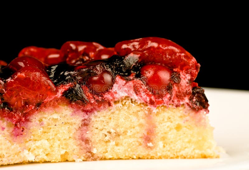 Bolo de veludo vermelho com cereja em um prato branco e uma xícara de café