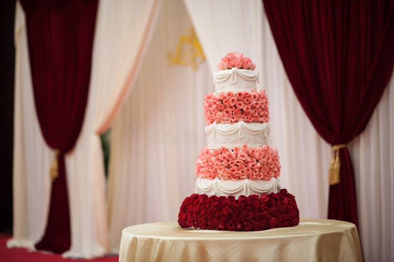 White flowers decorated three-tier wedding cake. White flowers decorated three-tier wedding cake