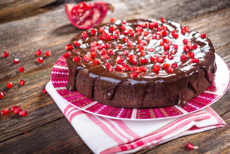 Chocolate cake with Pomegranate seeds on wooden background. Chocolate cake with Pomegranate seeds on wooden background.