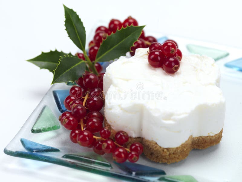 A flower shaped cheese cake with a christmas decoration. A flower shaped cheese cake with a christmas decoration