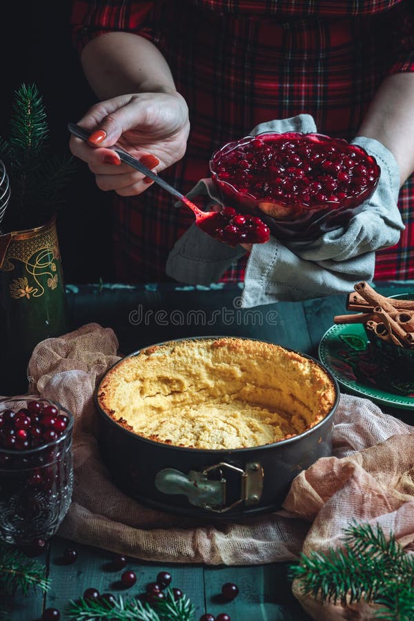 Traditional homemade french cake with cranberries served on green wooden table, cooking process. High quality photo. Traditional homemade french cake with cranberries served on green wooden table, cooking process. High quality photo