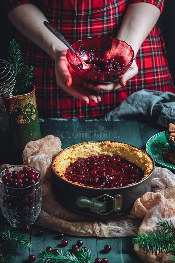 Traditional homemade french cake with cranberries served on green wooden table, cooking process. High quality photo. Traditional homemade french cake with cranberries served on green wooden table, cooking process. High quality photo