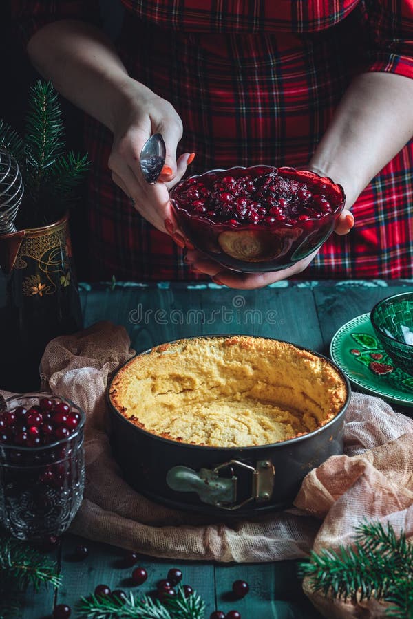 Traditional homemade french cake with cranberries served on green wooden table, cooking process. High quality photo. Traditional homemade french cake with cranberries served on green wooden table, cooking process. High quality photo