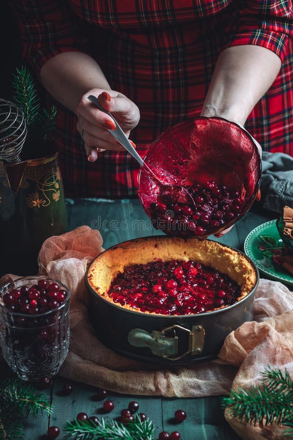 Traditional homemade french cake with cranberries served on green wooden table, cooking process. High quality photo. Traditional homemade french cake with cranberries served on green wooden table, cooking process. High quality photo