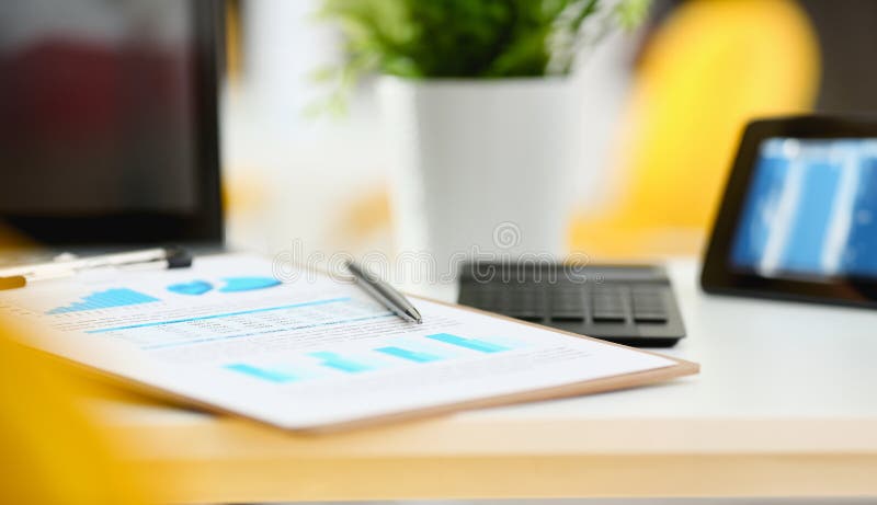 Silver pen lying on important stats paper clipped to pad at table workspace in office closeup. Trade result form paperwork job bank credit loan balance invest payment irs currency audit budget trend. Silver pen lying on important stats paper clipped to pad at table workspace in office closeup. Trade result form paperwork job bank credit loan balance invest payment irs currency audit budget trend