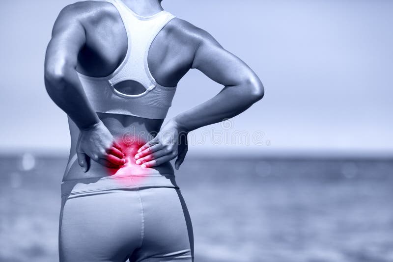 Back pain. Athletic running woman with back injury in sportswear rubbing touching lower back muscles standing on road outside. Back pain. Athletic running woman with back injury in sportswear rubbing touching lower back muscles standing on road outside.
