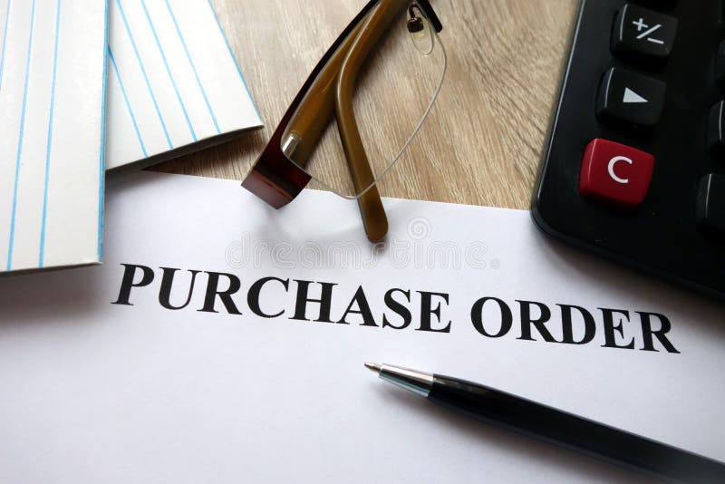 Purchase order document with pen, calculator and glasses on desk. Purchase order document with pen, calculator and glasses on desk