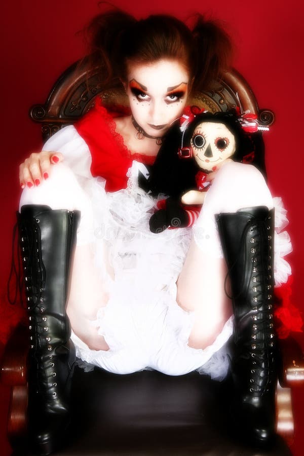 Artistic goth portrait of woman in goth doll dress with matching doll. Artistic goth portrait of woman in goth doll dress with matching doll.