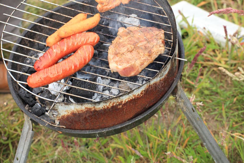 Bonfire Campfire Fire Flames Grilling Steak on the BBQ Stock Photo