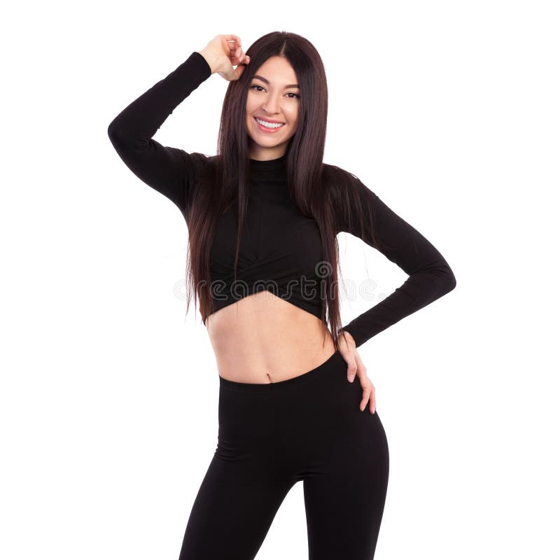 Bonita mulher de cabelo longo e bonito de terno preto isolada em fundo branco Feche o esporte e o belo corpo feminino fotografia de stock royalty free Bonita mulher de cabelo longo e bonito de terno preto isolada em fundo branco Feche o esporte e o belo corpo feminino fotografia de stock royalty free