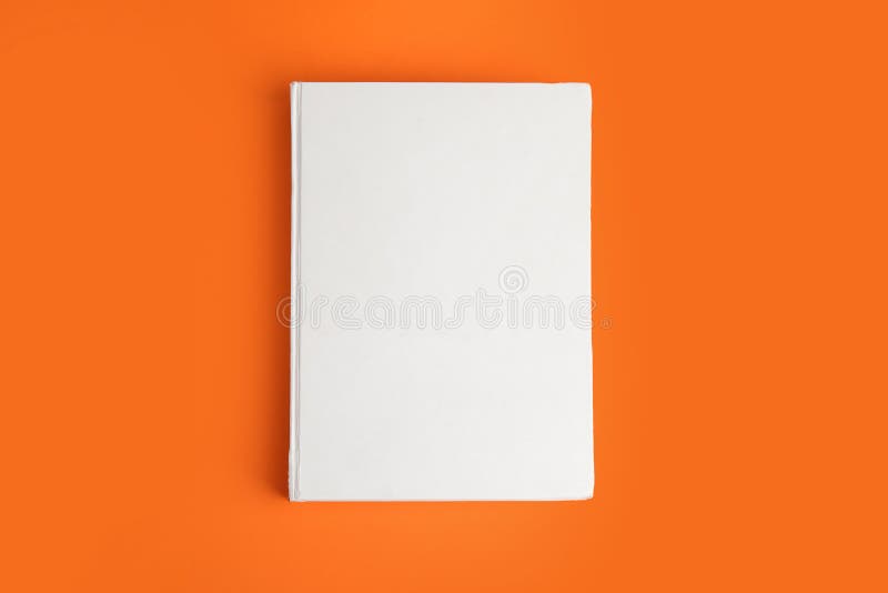 Book with blank cover on orange, top view