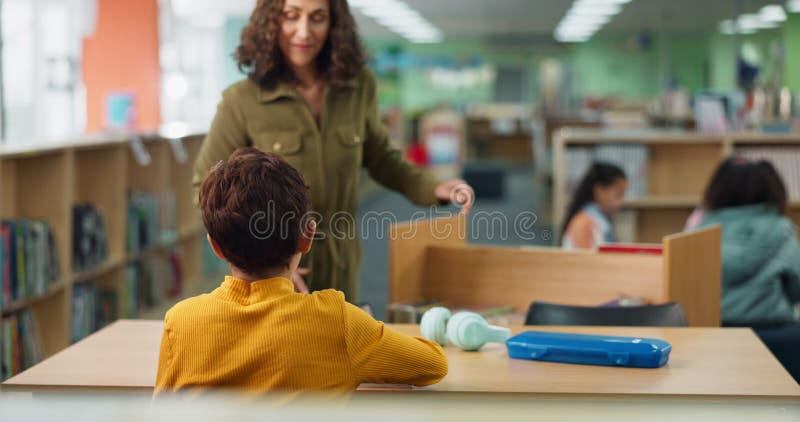 Book, child or student with hand up in library or classroom for learning development or question. Reading, polite stock footage