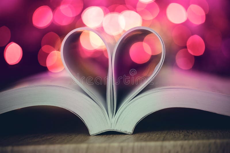 The Book page decorate to heart shape with celebration bokeh light for love and romance of valentines day concept. Book page decorate to heart shape with royalty free stock images