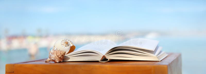 Book and shells on the beach wooden table. Book and shells on the beach wooden table